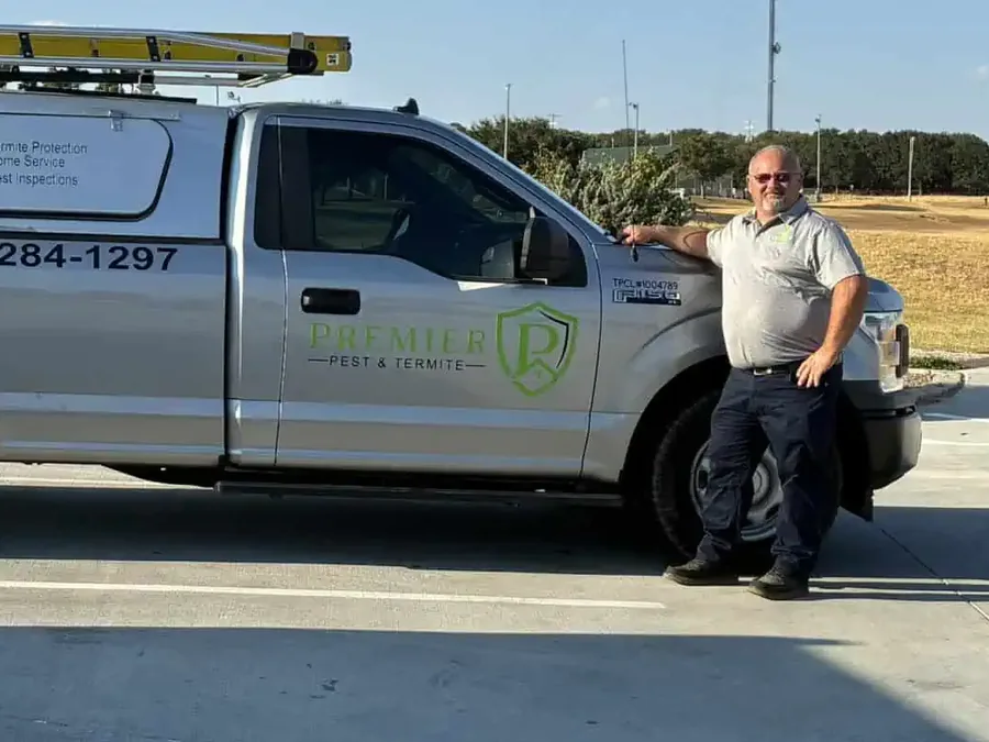 Stacy Tyner beside the Premier Pest & Termite truck in Bowie, Texas